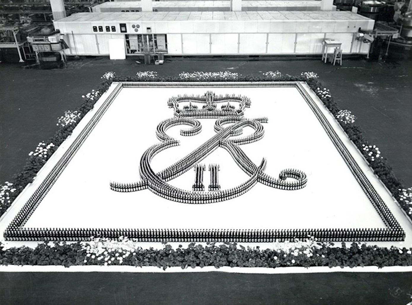 The royal cipher in an unusual setting at the brewery in Copenhagen. Nearly 5000 gold-topped bottles arranged to form the royal cipher E.R.I.I.