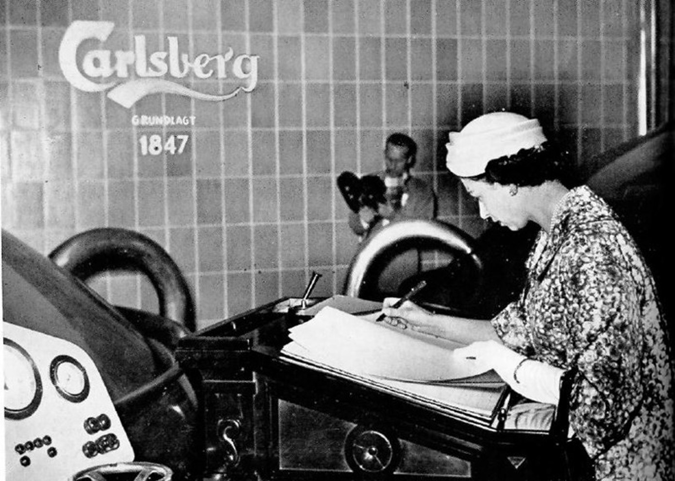 Queen Elizabeth II signs the Carlsberg guest book